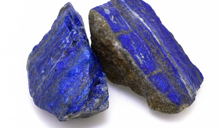 Two pieces of blue stone are sitting on a table.