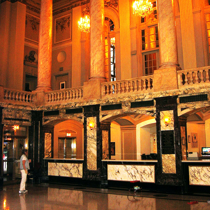 A woman is walking in front of the lobby.