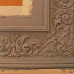 A close up of the ornate frame on a wall.