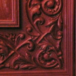 A close up of the wood carving on a door.
